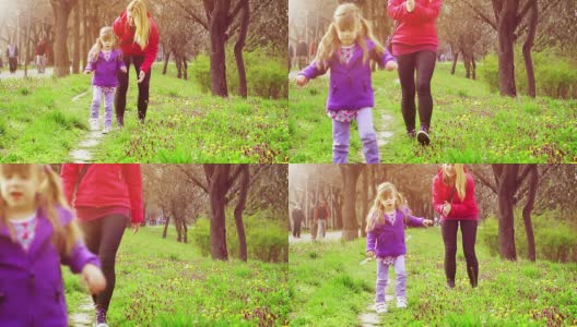 小女孩和妈妈一起在公园里学走路高清在线视频素材下载