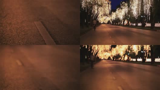 高清平移:路灯点缀在沿途的树木上。高清在线视频素材下载