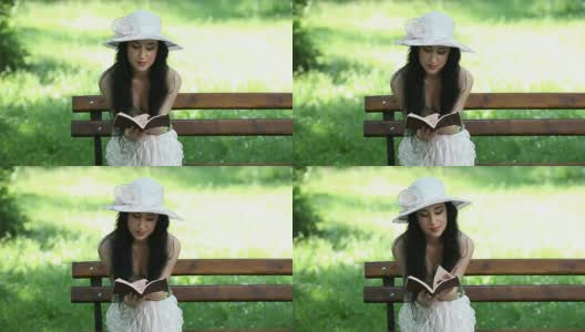 美丽的女孩在公园看书，放松高清在线视频素材下载