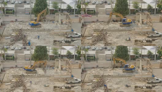 挖掘机清理建筑工地的混凝土残骸高清在线视频素材下载