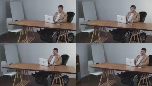 办公室里坐轮椅的商人高清在线视频素材下载