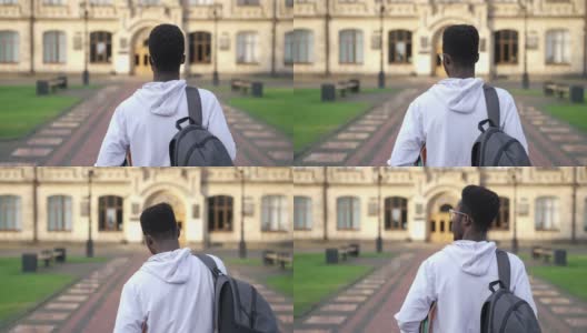 后视镜，自信的年轻学生步行到大学校园的慢镜头户外。一个聪明的非裔美国人，在春秋的一天，拿着书去上大学。教育智慧。高清在线视频素材下载