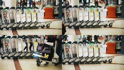 机场内用于运送行李的一排排行李车。高清在线视频素材下载
