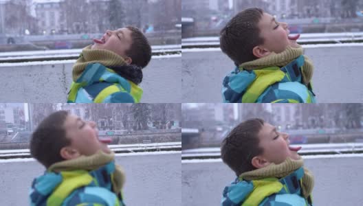 男孩喜欢雪花飘落在他的脸上高清在线视频素材下载