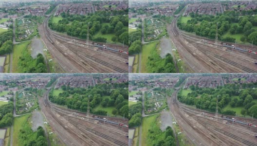 英国西约克郡利兹的奥斯蒙德索普村，一架无人机拍摄到的火车站和铁轨的视频显示，夏季有很多火车在铁轨上行驶高清在线视频素材下载