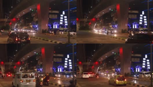 印度尼西亚雅加达市中心，夜间拥挤的道路上有汽车、摩托车和人群高清在线视频素材下载