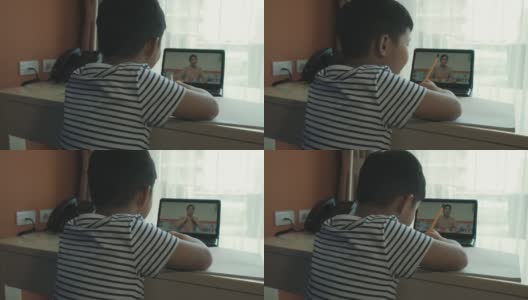 一个亚洲男孩在家参加在线课程。高清在线视频素材下载