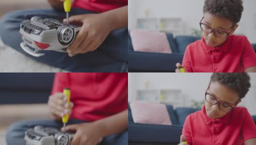 非裔美国男孩用螺丝刀修理坏了的玩具车，学习新技能高清在线视频素材下载