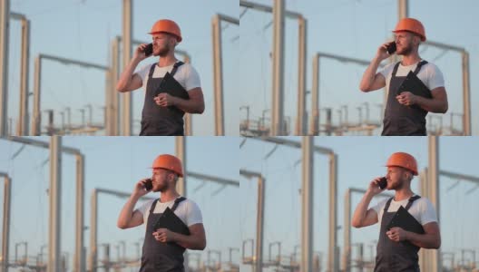 男子站在太阳能站用手机通话。高清在线视频素材下载