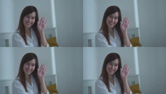 年轻的亚洲女人在卧室里做手势，飞吻高清在线视频素材下载