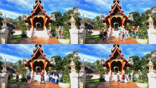 4K Loy Krathong节日-年轻的男人和女人拿着花架托盘和Krathong在寺庙周围散步高清在线视频素材下载