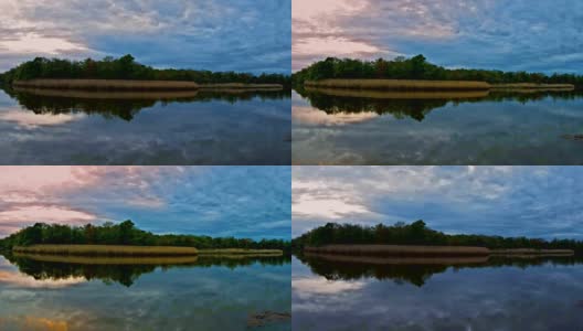 轻风暴云移动在一个野外地区生动的日落在水湖，与戏剧性的云运动和反射。FullHD高清视频高清在线视频素材下载