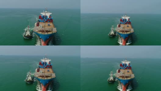 鸟瞰图或正面图拖船拖集装箱船从海港在海上行驶为物流进出口或运输。高清在线视频素材下载