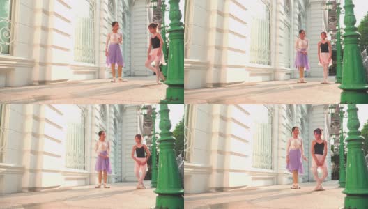 低角度视角:在一个阳光明媚的日子里，一名亚洲青少年芭蕾舞演员在一位年轻女芭蕾舞老师的建议下，在曼谷当地的街道上练习芭蕾舞。活跃的年轻妇女和孩子的概念周末活动和当地地标。高清在线视频素材下载