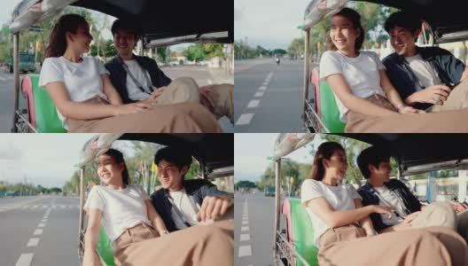 一对年轻夫妇在嘟嘟车上享受城市风景。高清在线视频素材下载