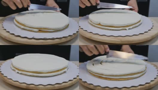 面包师糕点师用刀抹平蛋糕上的一层白奶油高清在线视频素材下载
