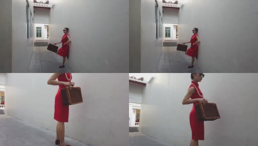 图为，在户外拍摄《时尚旗袍》时，背着行李戴着墨镜的中国年轻女子。高清在线视频素材下载