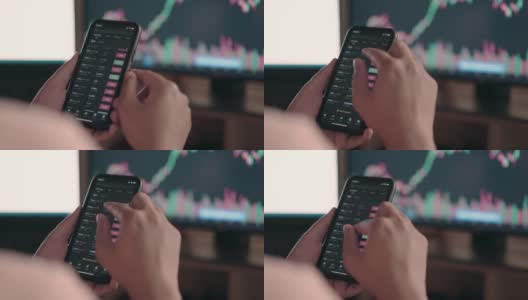 手指在智能手机上处理数据，显示器上显示加密货币图表高清在线视频素材下载