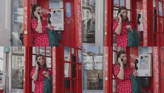 年轻开朗的女子在旧的红色电话亭里用智能手机聊天高清在线视频素材下载