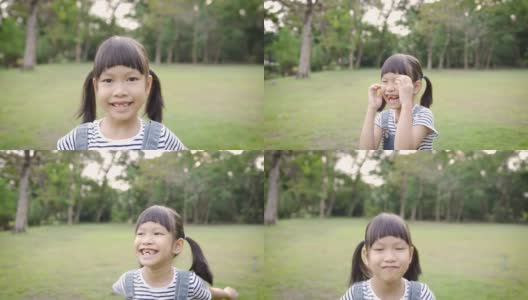 年轻快乐的亚洲小女孩有乐趣的肖像在公园高清在线视频素材下载