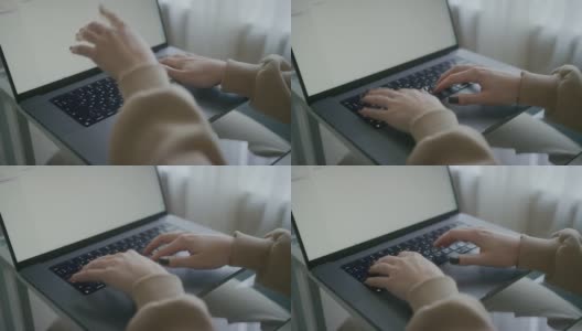 女人在笔记本电脑键盘上打字的手。正在撰写文章的记者。女士使用现代PC。女性博主家庭工作场所特写。宏。景深。4 k的片段高清在线视频素材下载