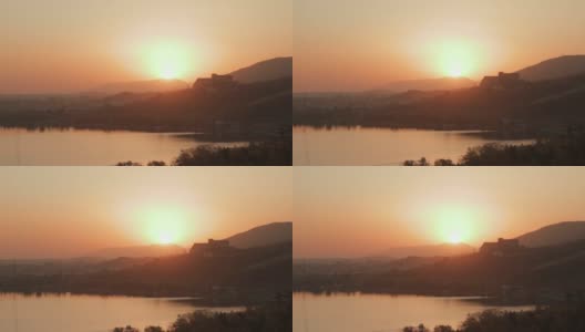 这是亚美尼亚塞万湖美丽日落的静态照片。温馨的心情和温暖的颜色在塞文半岛高清在线视频素材下载
