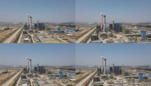 在运行中的化工厂旁边的未完工的建筑工地的鸟瞰图视频高清在线视频素材下载