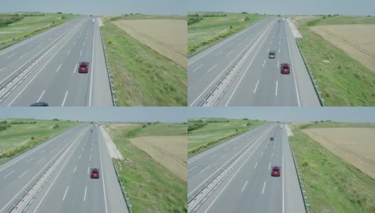 航拍，慢镜头红色四驱车行驶在空无一人的高速公路上。高清在线视频素材下载