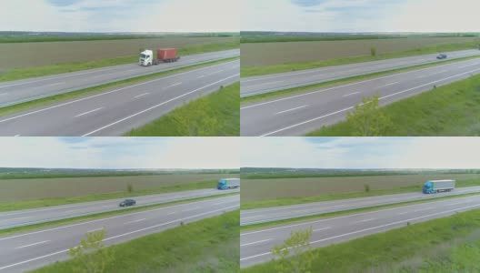 卡车在现代高速公路上骑在绿色的草地上俯瞰。无人机可以看到高速公路上的卡车。高清在线视频素材下载