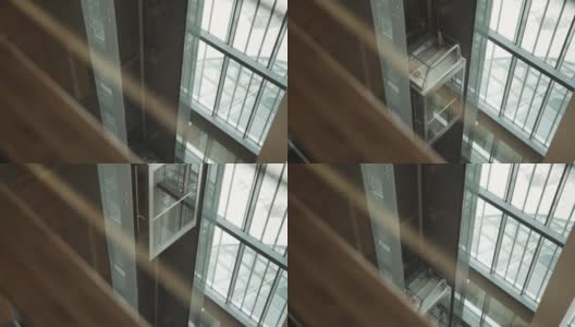 开放式玻璃透明电梯轿厢在建筑内部升起。高清在线视频素材下载