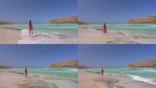 Balos海滩。克里特岛,希腊。那个女孩正在海边散步。空中无人机拍摄。高清在线视频素材下载