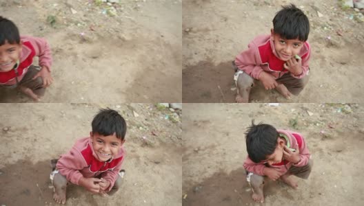 一个兴高采烈的印度乡村男孩看着相机高清在线视频素材下载