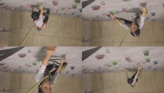 年轻的印尼青少年攀岩运动员爬墙高清在线视频素材下载