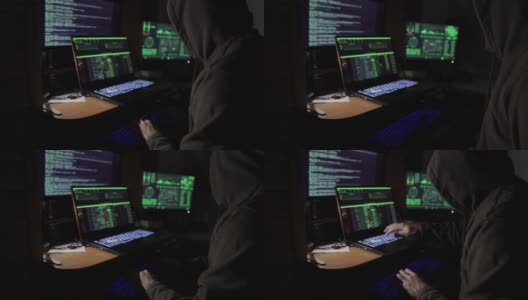 一名黑客在暗室里的显示器前试图黑进安全系统高清在线视频素材下载