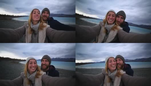 一对年轻夫妇在新西兰的湖岸自拍高清在线视频素材下载