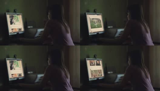 那个女孩正坐在桌子旁玩电脑。高清在线视频素材下载