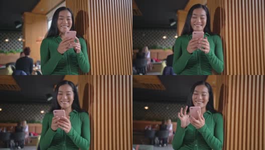 在候机室等待下机的时候，亚裔现代女性使用手机高清在线视频素材下载