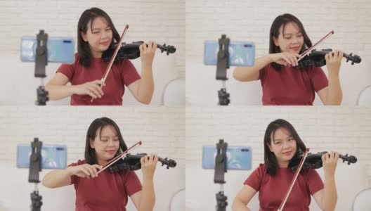 亚洲女教师在家教学生如何演奏古典乐器小提琴高清在线视频素材下载