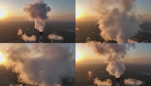 从空中俯瞰日落时冒烟的发电站烟囱高清在线视频素材下载