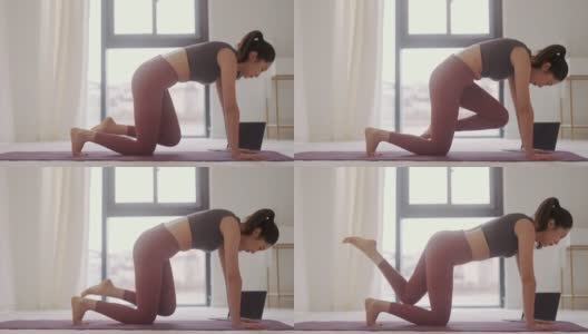 年轻的日本女性在瑜伽垫上伸展身体高清在线视频素材下载