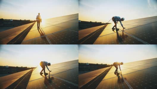 日落后，身着制服的维修助理技术工人正在检查屋顶光伏太阳能板的操作及效率表现。前视图高清在线视频素材下载