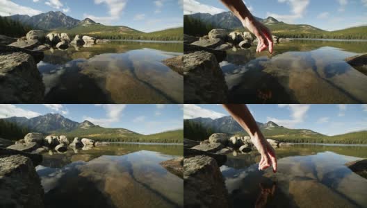 手指触碰湖面。日落高清在线视频素材下载