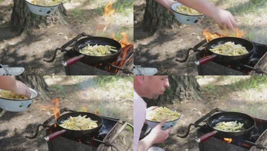 男人在篝火上准备炸土豆。高清在线视频素材下载