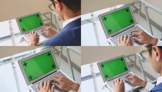 商人使用绿色屏幕的笔记本电脑高清在线视频素材下载