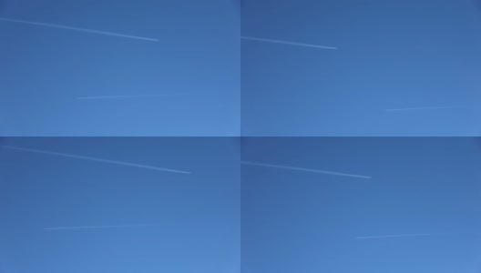 两架喷气式飞机在高空互相飞行，在清澈的蓝天上留下了尾迹。高清在线视频素材下载