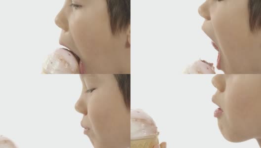 一个混血男孩舔冰淇淋的特写镜头。高清在线视频素材下载