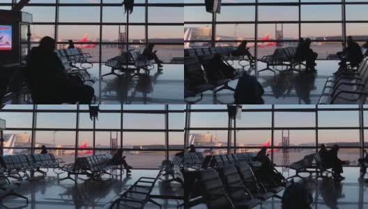 俄罗斯莫斯科——2021年11月21日:伏努科沃机场航站楼门摄影。等待航班的人们在候机楼里坐着或走着高清在线视频素材下载