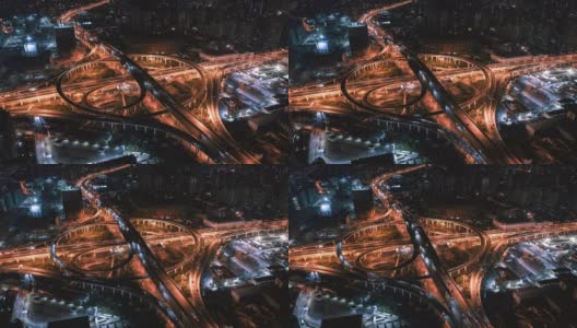 高速公路十字路口和上海市区空中立交桥夜景。巨大的道路交叉口，从上面可以看到繁忙的交通。高清在线视频素材下载