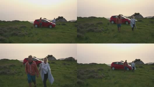 男人和女人走在草地上远离汽车高清在线视频素材下载
