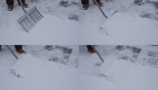 一个人正在用铲雪铲雪，清理道路。高清在线视频素材下载